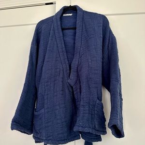 Thick indigo cotton wrap sweater with pockets and tie.